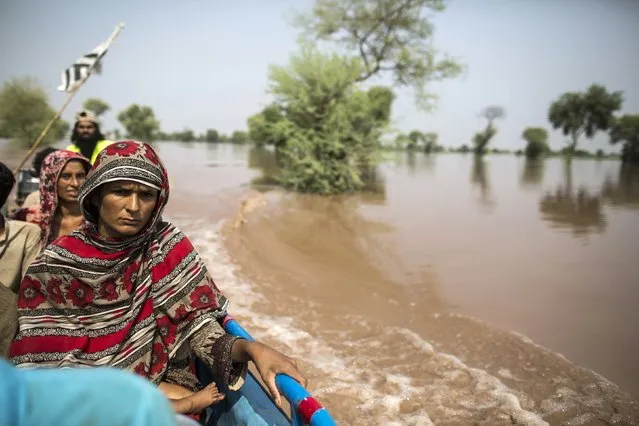 A flood victim sits on a boat while being evacuated from her flooded house following heavy rain in Jhang, Punjab province September 10, 2014. The prime ministers of India and Pakistan have offered to help each other in efforts to alleviate flood havoc in the disputed Himalayan region of Kashmir, lowering tension between the rival nations after weeks of army clashes and heated rhetoric. (Photo by Zohra Bensemra/Reuters)