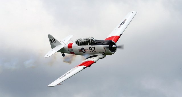  A pilot performs aerobatics in a vintage Harvard aircraft during an airshow commemorating the completion of the the rebuild of Havilland Mosquito KA 114, on September 29, 2012 in Ardmore, New Zealand. The plane was restored by Warbird Restorations at Ardmore Aerodrome and is the only flying Mosquito in the world.  (Photo by Simon Watts)