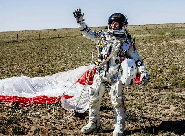 Baumgartner celebrates after successfully completing the jump. (Photo by Balazs Gardi/Red Bull Stratos)