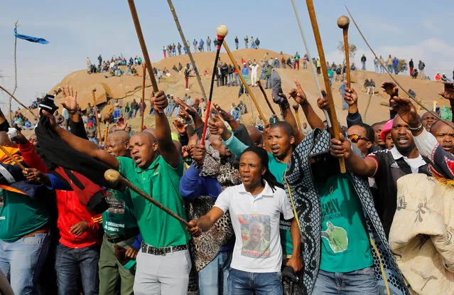 Members of the Association of Mineworkers and Construction Union (AMCU) dance and sing around Wonderkop Hill during the 4th anniversary of the Marikana shooting in Rustenburg, South Africa, 16 August 2016. Police forces shot dead 34 miners from the Lonmin mine four years ago after a protracted strike in the mining sector. Relatives and fellow miners gather at Wonderkop hill each year to remember those who died and were wounded. (Photo by Kim Ludbrook/EPA)