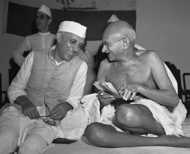 Bespectacled Mahatma Gandhi, who eventually led India to its independence, laughs with the man who was to be the nation's first prime minister, Jawaharlal Nehru, at the All-India Congress committee meeting in Bombay, India, on July 6, 1946. Nehru took office as president of the Congress during the session. Gandhi's philosophy of non-violent resistance, including civil disobedience and fasts, drove India to independence in 1947 after nearly 200 years of British rule. The father of modern India, the Mahatma, which means great soul, was assassinated in 1948 for his tolerance of other religions. (Photo by Max Desfor/AP Photo)