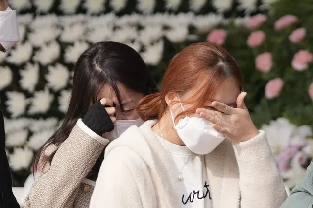 Mourners weep after they pay tribute to the victims of a deadly accident following Saturday night's Halloween festivities, at a joint memorial altar for victims at Seoul Plaza in Seoul, South Korea, Tuesday, November 1, 2022. South Korea's police chief admitted “a heavy responsibility” for failing to prevent a recent crowd surge that killed more than 150 people during Halloween festivities in Seoul, saying Tuesday that officers didn't effectively handle earlier emergency calls about the impending disaster. (Photo by Lee Jin-man/AP Photo)