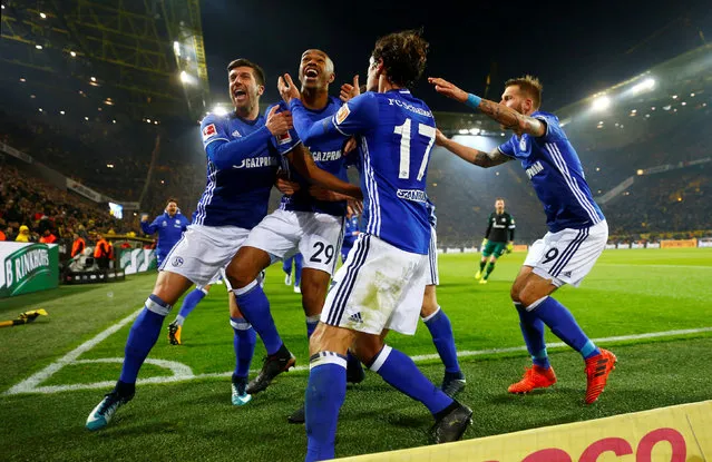 Schalke' s scorer Naldo, front, celebrates his side`s 4th goal during the German Bundesliga soccer match between Borussia Dortmund and FC Schalke 04 in Dortmund, Germany, Saturday, November 25, 2017. The match ended in a 4-4 draw. (Photo by Wolfgang Rattay/Reuters)