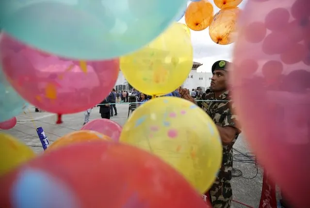 A Nepalese army personnel decorates the premises of the parliament before President Ram Baran Yadav formally promulgates the new constitution in Kathmandu, Nepal September 20, 2015. (Photo by Navesh Chitrakar/Reuters)