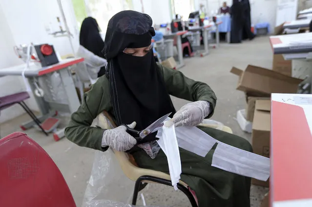 Yemeni seamstresses make protective masks at a textile factory in the capital Sanaa, on June 7, 2020, amid the novel coronavirus pandemic. (Photo by Mohammed Huwais/AFP Photo)