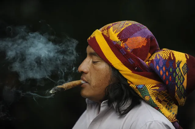 A Mayan shaman performs a ritual at the Quirigua archaeological site, Izabal department, 210 km north of Guatemala City. Ceremonies will be held here to celebrate the end of the Mayan cycle known as Bak'tun 13 and the start of the new Maya Era on December 21. The Mayan calendar has 18 months of 20 days each plus a sacred month, “Wayeb”, with five days. “B'aktun” is the largest unit in the time-cycle system, and is about 400 years. The broader era spans 13 B'aktun, or about 5,200 years. (Photo by Johan Ordonez)