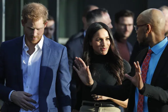 Britain's Prince Harry and his fiancee Meghan Markle leave the Nottingham Academy in Nottingham, England , Friday, December 1, 2017. It was announced on Monday that Prince Harry and American actress Meghan Markle are engaged and will marry in the spring of 2018. (Photo by Frank Augstein/AP Photo)