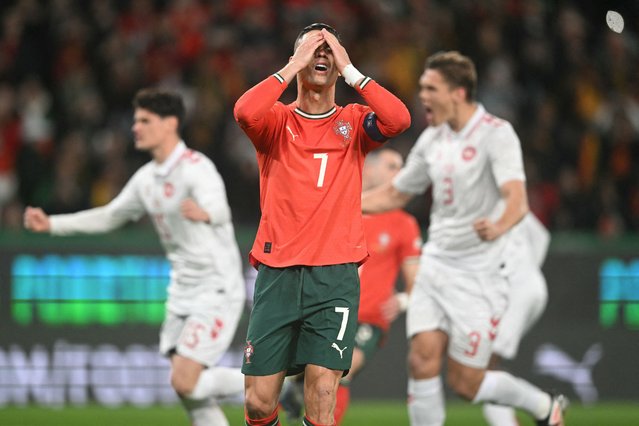 Portugal's forward #16 Cristiano Ronaldo reacts to missing a goal after shooting from the penalty spot during the UEFA Nations League quarter final second leg football match between Portugal and Denmark at the Jose Alvalade stadium in Lisbon, on March 23, 2025. (Photo by Patricia de Melo Moreira/AFP Photo)