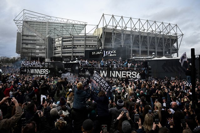Newcastle United's players celebrate on an open-top bus with the League Cup trophy as they parade past St James' Park and through the city of Newcastle upon Tyne in north-east England on March 29, 2025, after winning the English League Cup, their first domestic trophy for 70 years. (Photo by Oli Scarff/AFP Photo)