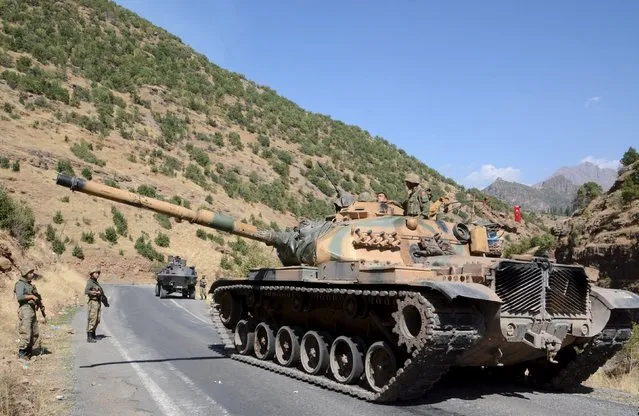 Turkish soldiers in a tank and an armored vehicle patrol on the road to the town of Beytussebab in the southeastern Sirnak province, Turkey, September 28, 2015. Five children were wounded on Monday when a bomb tore through a street in the Turkish city of Diyarbakir, hospital officials said, where deadly clashes in recent weeks have followed the collapse of ceasefire by Kurdish militants. (Photo by Reuters/Stringer)