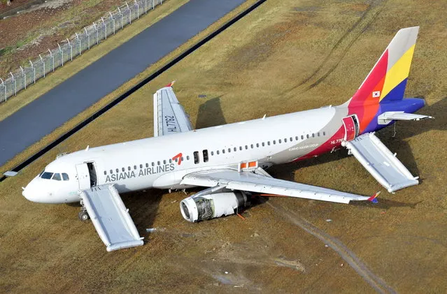 An aerial view shows an Asiana Airlines airplane which ran out of runway after landing at Hiroshima airport in Mihara, Hiroshima prefecture, western Japan, in this photo taken by Kyodo April 15, 2015. An investigation has been launched after the Asiana Airlines passenger jet skidded off the runway after landing at Japan's Hiroshima airport on Tuesday, local media reported. The Airbus A320 jet was arriving from the South Korean capital of Seoul when it ran off the runway and slid onto an embankment shortly after 8pm local time (1100 GMT). (Photo by Kyodo News via Reuters)