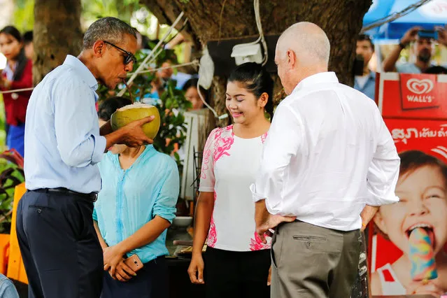 U.S. President Barack Obama drinks water of a fresh-cut coconut on a walk in Luang Prabang, Laos September 7, 2016. (Photo by Jonathan Ernst/Reuters)