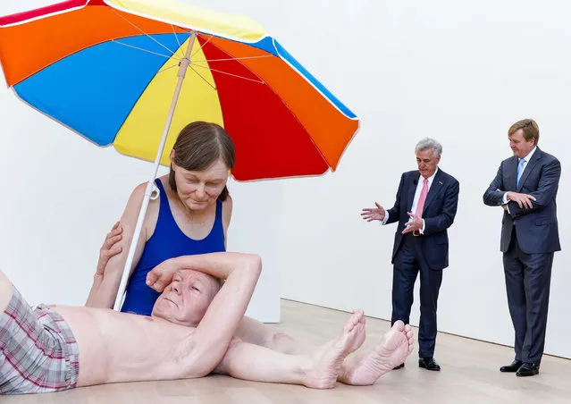 Dutch King Willem-Alexander (R) listens to Dutch industrialist and art collector Joop van Caldenborgh (L) next to the artwork “Couple under an Umbrella” by Australian artist Ron Mueck during the opening of the new Museum Voorlinden in Wassenaar, The Netherlands, 10 September 2016. Museum Voorlinden is a private museum of modern and contemporary art at the Estate Voorlinden. (Photo by Bart Maat/EPA)