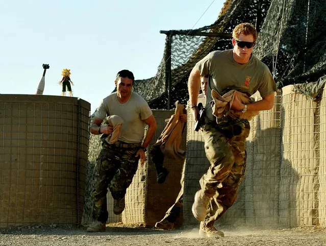 In this photo made available today, Prince Harry races out from the VHR (very high ready-ness) tent to scramble his Apache with fellow pilots, during his 12 hour shift at the British controlled flight-line in Camp Bastion on November 3, 2012. The Ministry of Defense announced Monday that the 28-year-old prince is returning from his 20-week deployment. (Photo by John Stillwell/Associated Press)