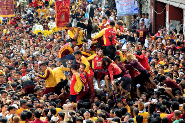Devotees jostle one another as they try to touch the Black Nazarene replica during an annual procession in Quiapo city, Metro Manila, Philippines January 7, 2018. (Photo by Romeo Ranoco/Reuters)