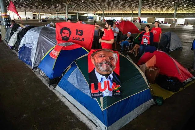 Supporters of President-elect Luiz Inacio Lula da Silva camp at the Brasilia Exhibition Pavilion to attend his inauguration ceremony, in Brasilia, on December 31, 2022. Lula da Silva, a 77-year-old leftist who already served as president of Brazil from 2003 to 2010, takes office for the third time with a grand inauguration in Brasilia on January 1, 2023. (Photo by Sergio Lima/AFP Photo)