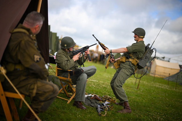 American World War re-enactors pose for their friend to photograph at TANKFEST 2025 at The Tank Museum on June 27, 2025 in Bovington, Dorset. The Tank Museum holds the world's largest collection of tanks, covering the period from the First World War to the present day. TANKFEST is a three day event featuring the world's biggest live display of historic armor. (Photo by Finnbarr Webster/Getty Images)