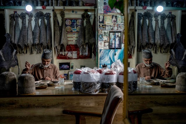 Saleem Arghandiwal, an artisan, makes Karakul or Qaraqul hats at his embroidery shop in Kabul on May 27, 2025, crafted from the fur of a newborn lamb of the same breed of sheep. (Photo by Wakil Kohsar/AFP Photo)