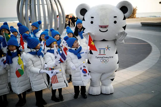 Children look on the 2018 PyeongChang Winter Olympics mascot Soohorang in Gangneung, South Korea, February 8, 2018. (Photo by Kim Hong-Ji/Reuters)