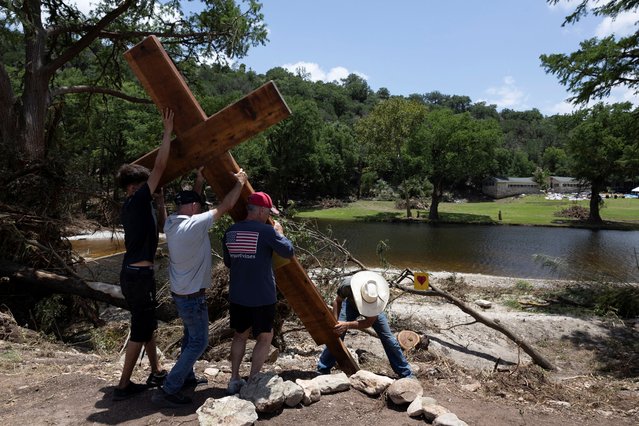 People place a cross by the Guadalupe River, across from Camp Mystic, following deadly flooding, in Hunt, Texas, U.S., July 10, 2025. (Photo by Umit Bektas/Reuters)