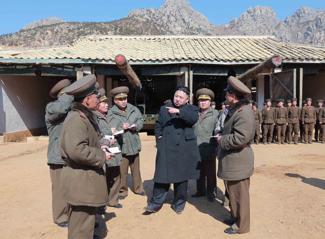 In this March 11, 2013 photo released by the Korean Central News Agency (KCNA) and distributed March 12, 2013 by the Korea News Service, North Korean leader Kim Jong Un, center, confers with military officers at a long-range artillery sub-unit of KPA Unit 641 during his visit to front-line military units near the western sea border in North Korea near the South's western border island of Baengnyeong. Kim urged front-line troops to be on “maximum alert” for a potential war as a state-run newspaper said Pyongyang had carried out a threat to cancel the 1953 armistice that ended the Korean War.  (Photo by AP Photo/KCNA via KNS)