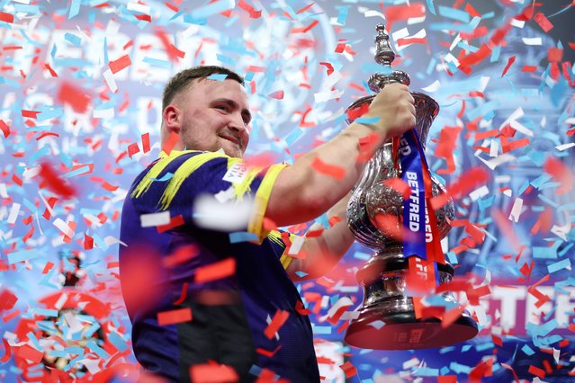 Luke Littler of England celebrates with The Phil Taylor Trophy after victory in the Final match between James Wade of England and Luke Littler of England on day nine of the 2025 Betfred World Matchplay at Winter Gardens on July 27, 2025 in Blackpool, England. (Photo by Lewis Storey/Getty Images)
