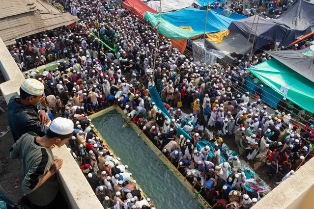 Muslim devotees gather to use water supplied during Bishwa Ijtema in Tongi, Dhaka, Bangladesh on January 20, 2023. The Bishwa Ijtema (Global Congregation) is an annual gathering of Muslims in Tongi, by the banks of the River Turag, on the outskirts of Dhaka, Bangladesh. It is the second largest congregation of the Muslim community after the pilgrimage to Mecca for the Hajj. The Ijtema is a prayer meeting spread over three days, during which attending devotees perform daily prayers while listening to scholars reciting and explaining verses from the Quran. Because of being non-political, it draws people of all persuasion and is attended by devotees from 150 countries. (Photo by Joy Saha/Rex Features/Shutterstock)