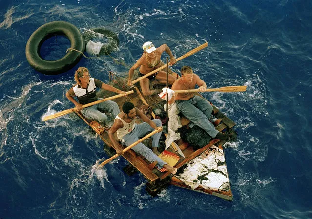 Cuban refugees row a makeshift raft in the Florida straits, August 25, 1994. The refugees were picked up by the U.S. Coast Guard cutter Gallatin and were then transferred to a Navy ship which would transport them to a refugee camp at the U.S. Naval Base in Guantanamo Bay, Cuba. (Photo by Steve Helber/AP Photo)