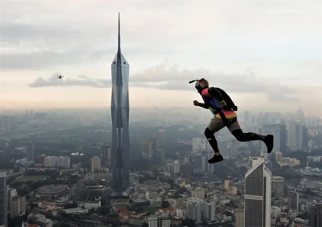 A base jumper leaps off the Kuala Lumpur Tower during the annual KL Tower International Jump Malaysia 2023 at Kuala Lumpur, Malaysia on February 3, 2023. (Photo by Hasnoor Hussain/Reuters)