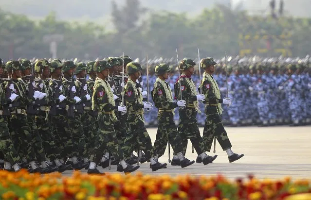 A guard of honour contingent marches during a parade to mark the 68th anniversary of Armed Forces Day in Myanmar's capital Naypyitaw March 27, 2013.  The parade commemorates the day, March 27, 1945, when independence hero General Aung San gave the command to the units of the independence army to launch a nation-wide resistance against the Japanese occupation. (Photo by Soe Zeya Tun/Reuters)