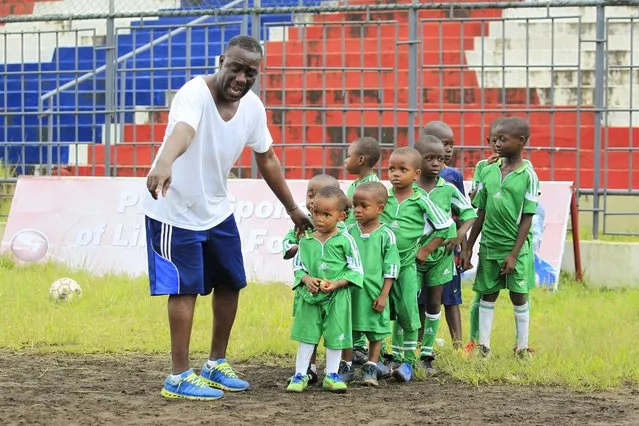 Haizel Gray (L) administering pyhisical exercises for soccer academy kids at the Antoinette Tubman Stadium in Monrovia, Liberia, 01 October 2016. The national youth soccer academy was established in March 2009 by former national soccer players and enthusiasts, purposely to take kids from the streets, communities  and bring them to the stadium,  develop, improve and teach them the  technical, tactical basic skills in playing soccer, the academy also teach them hygiene and HIV awareness. The soccer academy has five former national players, who serves as coaches, and charges a fee of two US dollars for a kid per month, with an enrollment of about  50 kids in the academy. The academy helps kids obtain scholarships for schooling, and kids in turn plays for the school soccer team. The academy  comprises of wayward, street, and  communities kids, who drinks alcoholic beverages, which is widely blamed, due to 14 years of civil crisis and high  unemployment rate of Liberians, which left parents incapable of taking care of their children and thereby, left children vulnerable and faces the negative consequences of life. The Liberia Football Association (LFA) partners with the National Street Soccer Academy and provides its stadium facilities for use as practices venue, free of charge to the Academy. (Photo by Ahmed Jallanzo/EPA)