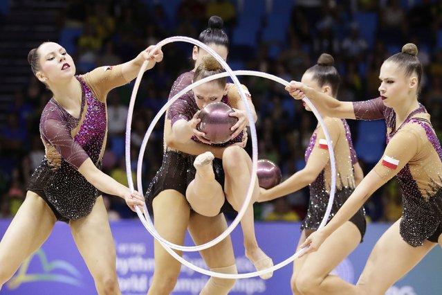 Poland's team competes with hoops and balls during the group all-around final at the 41st FIG Rhythmic Gymnastics World Championships at Carioca Arena, in Rio de Janeiro, Saturday, August 23, 2025. (Photo by Bruna Prado/AP Photo)