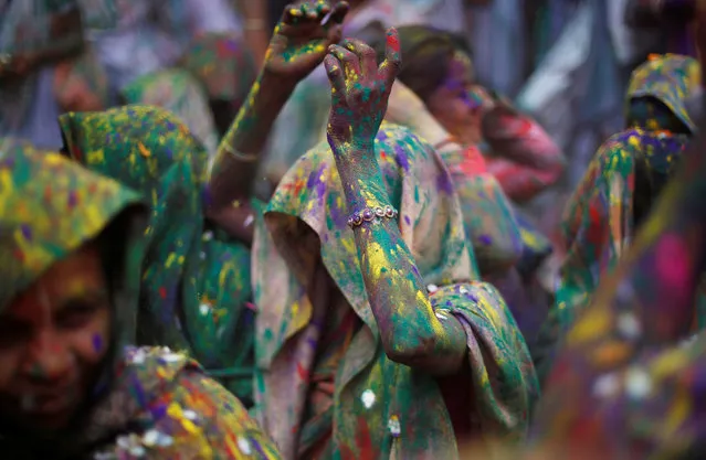 Widows daubed in colours dance as they take part in Holi celebrations in the town of Vrindavan in the northern state of Uttar Pradesh, India, February 27, 2018. (Photo by Adnan Abidi/Reuters)