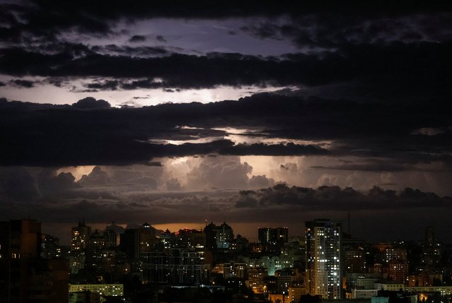 A flash from the lightning illuminates the sky over the city before a night storm in Kyiv, Ukraine on June 4, 2024. (Photo by Gleb Garanich/Reuters)