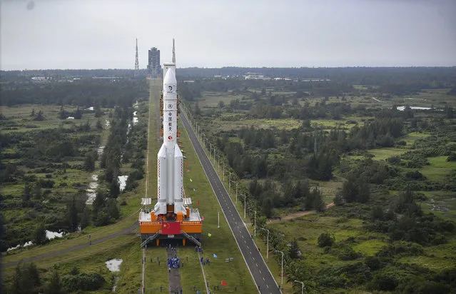 In this November 17, 2020, photo released by China's Xinhua News Agency, a Long March-5 rocket is moved at the Wenchang Space Launch Site in Wenchang in southern China's Hainan Province. Chinese technicians were making final preparations Monday, Nov. 23, 2020, to launch a Long March-5 rocket carrying a mission to bring back material from the lunar surface in a potentially major advance for the country's space program. (Photo by Guo Cheng/Xinhua via AP Photo)