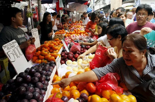 Filipinos buy different round shape fruits ahead of the New Year eve celebration at the fruit store in Manila in this December 29, 2010 file photo. (Photo by Romeo Ranoco/Reuters)