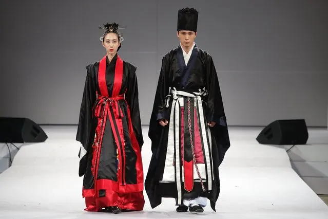 Models walk down the catwalk during the South Korean Traditional Costume “HanBok” fashion show at Gyeongbok Palace on October 22, 2016 in Seoul, South Korea. Hanbok is the traditional Korean dress. It is often characterized by vibrant colors and simple lines without pockets. Although the term literally means “Korean clothing”, hanbok today often refers specifically to hanbok of Joseon Dynasty and is worn as semi-formal or formal wear during traditional festivals and celebrations. (Photo by Chung Sung-Jun/Getty Images)