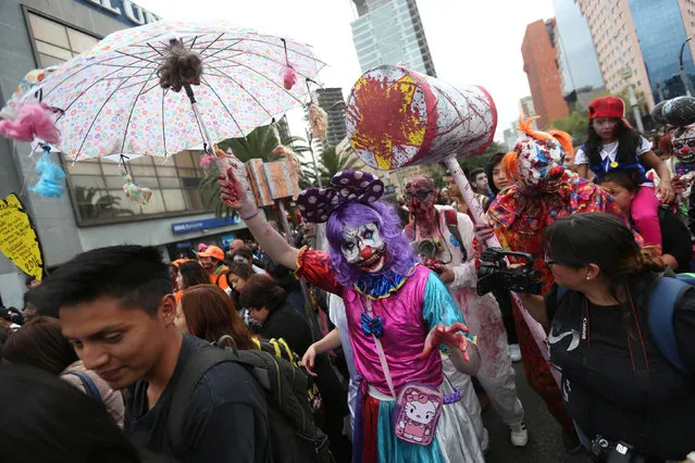 People dressed as zombies participate in a Zombie Walk procession in Mexico City, Mexico, October 22, 2016. (Photo by Edgard Garrido/Reuters)
