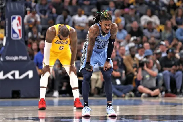 Ja Morant #12 of the Memphis Grizzlies and LeBron James #6 of the Los Angeles Lakers during the first half of Game Five of the Western Conference First Round Playoffs at FedExForum on April 26, 2023 in Memphis, Tennessee. (Photo by Justin Ford/Getty Images)