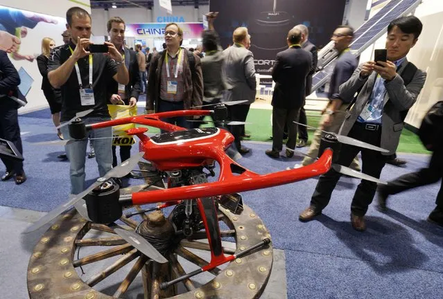People photograph a large Harwar Ace Unmanned Aerial Vehicle (UAV) system at the International Consumer Electronics show (CES) in Las Vegas, Nevada January 6, 2015. (Photo by Rick Wilking/Reuters)