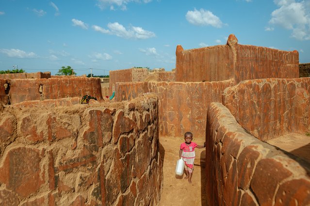 Tiebele village stands out with its earthen houses adorned with geometric patterns and its unique architecture recognized by UNESCO as part of the cultural heritage list in Nahouri, southern Burkina Faso on October 8, 2025. Reflecting the traditional lifestyle of the Kassena tribe the village captivates visitors with its artistic character. The houses called sukhala, are built by the men of the village using a mixture of mud and straw, after which the women decorate the walls with geometric patterns symbolizing fertility, protection and communal identity in black, red, and white using natural pigments. (Photo by Mehmet Aslan/Anadolu via Getty Images)