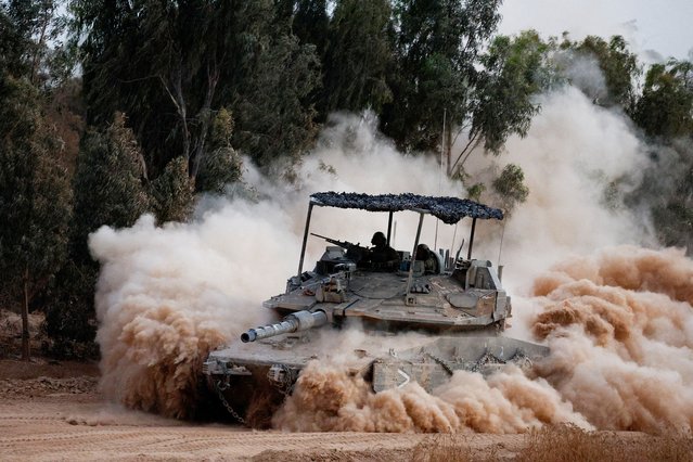 An Israeli tank maneuvers near the Israel-Gaza border as it returns from Gaza, amid the Israel-Hamas conflict, as seen from Israel on July 4, 2024. (Photo by Amir Cohen/Reuters)