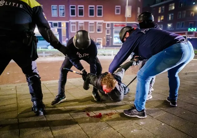 A man is arrested by Police during clashes in Rotterdam, The Netherlands, 25 January 2021. Police's mobile unit is present and has carried out charges to clear the street. Some arrests have also been made and a water cannon has been used. Nationwide protest against coronavirus restrictions and curfew imposed by Dutch government broke out during the weekend in many Dutch cities, leading to some violent riots and clashes with Police. (Photo by Marco de Swart/EPA/EFE)