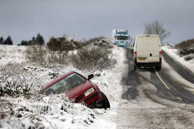 A crashed car sits at the side of a road after heavy snowfall near the village of Carndonagh in Ireland January 13, 2015. (Photo by Cathal McNaughton/Reuters)