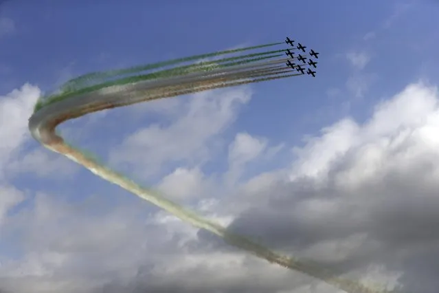 The Italian Air Force acrobatic squad “Frecce Tricolori” (three-color arrows) maneuver above Rome's skyline during the celebrations for the Armed Forces Day, Friday, November 4, 2016. The Armed Force Day marks the anniversary of the end of World War I for Italy, on November 4, 1918. (Photo by Gregorio Borgia/AP Photo)
