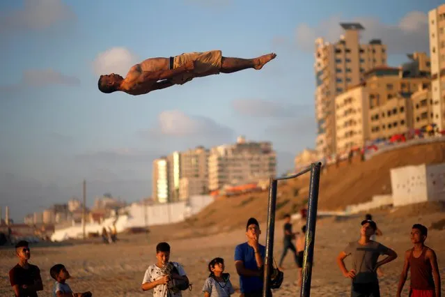 A Palestinian man demonstrates his parkour skills on a beach as the coronavirus disease (COVID-19) restrictions ease in Gaza City on July 10, 2020. (Photo by Mohammed Salem/Reuters)