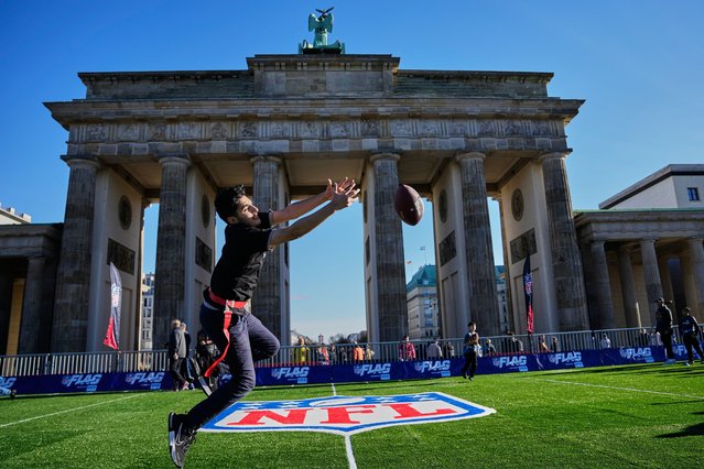 Children play flag football on a mini flag football field, set up in front of the Brandenburg Gate in Berlin, Germany, Thursday, November 6, 2025, during an event promoting the NFL ahead of the upcoming game between the Indianapolis Colts and the Atlanta Falcons. (Photo by Ebrahim Noroozi/AP Photo)