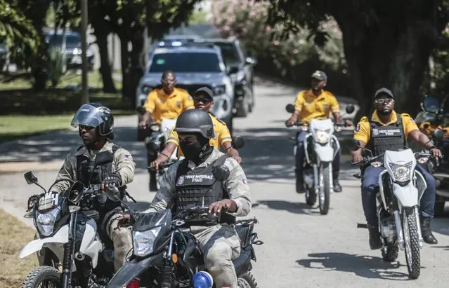 Police escort a FIFA delegation as part of a global tour ahead of the Women’s World Cup, in Port-au-Prince, Haiti, Saturday, April 15, 2023. The delegation is scheduled to travel with the iconic trophy to all 32 participating nations of the soccer tournament which kicks off on July 20th, co-hosted by Australia and New Zealand. (Photo by Joseph Odelyn/AP Photo)