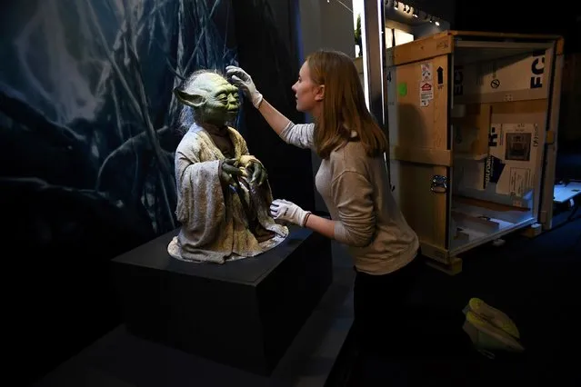 Lucas Museum of Narrative Art (LMNA) registrar Nicole Manis, from San Francisco, helps unpack the Yoda puppet used in the original movies, at the Star Wars Identities exhibition at the 02 in London, Britain, November 8, 2016. (Photo by Dylan Martinez/Reuters)