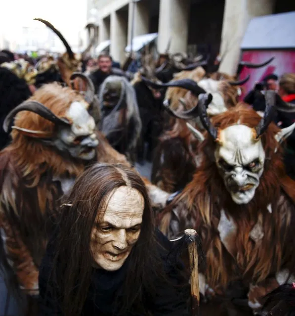 Men dressed as 'Krampuss' prepare to parade at Munich's Christmas market, December 13, 2015. (Photo by Michael Dalder/Reuters)